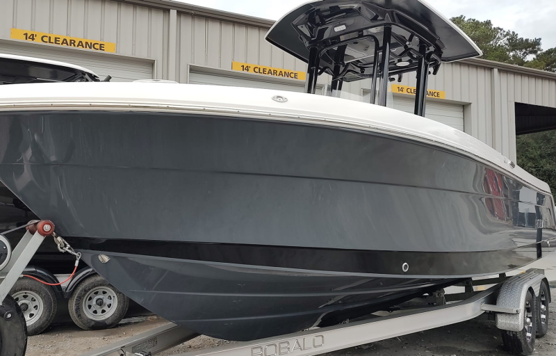 Gray center console boat with white trim and cover